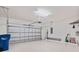 A well-lit garage with a garage door and storage racks offering ample space at 5115 Tobermory Way, Bradenton, FL 34211