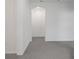 Hallway featuring neutral carpet and a bright recessed light at 5115 Tobermory Way, Bradenton, FL 34211