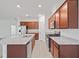 Open concept kitchen with stainless steel appliances, granite countertops, and island sink at 5115 Tobermory Way, Bradenton, FL 34211