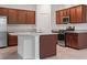 Modern kitchen features stainless appliances, white countertops, and dark wood cabinetry at 5115 Tobermory Way, Bradenton, FL 34211