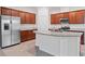 Bright kitchen with stainless steel appliances, granite counters, and ample cabinet space at 5115 Tobermory Way, Bradenton, FL 34211