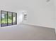 Spacious living room with neutral carpet and sliding glass door leading outside at 5115 Tobermory Way, Bradenton, FL 34211