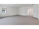 Large living room with neutral carpet, bright natural light, and an open floor plan at 5115 Tobermory Way, Bradenton, FL 34211