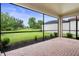 Enclosed patio features brick flooring and views of the surrounding landscape at 5115 Tobermory Way, Bradenton, FL 34211