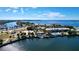 Beautiful aerial view of waterfront property with marina, pool, and lush tropical landscaping on a sunny day at 525 Bahia Beach Blvd, Ruskin, FL 33570