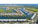 Stunning aerial showcasing waterfront community with boat docks, lush greenery and residential homes at 525 Bahia Beach Blvd, Ruskin, FL 33570