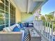 Cozy outdoor balcony featuring wicker furniture, stylish cushions, and a modern black and white rug at 525 Bahia Beach Blvd, Ruskin, FL 33570
