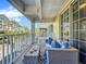 Charming balcony area showcasing comfortable seating, pillows and a coffee table with coastal decor at 525 Bahia Beach Blvd, Ruskin, FL 33570