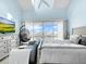 Bright bedroom features a hanging chair, waterfront views, and neutral decor at 525 Bahia Beach Blvd, Ruskin, FL 33570