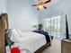 Bright bedroom features a ceiling fan and a sliding glass door to a private balcony at 525 Bahia Beach Blvd, Ruskin, FL 33570