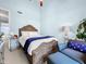 This bright bedroom features a ceiling fan, side table, and cozy chair at 525 Bahia Beach Blvd, Ruskin, FL 33570