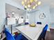 Bright dining area with a modern chandelier and view of the adjacent kitchen at 525 Bahia Beach Blvd, Ruskin, FL 33570