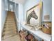 Inviting entryway with staircase, console table, decorative objects, and a large framed horse print at 525 Bahia Beach Blvd, Ruskin, FL 33570