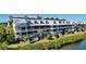 Sprawling condo complex with multiple units, private balconies, manicured landscaping, and water views at 525 Bahia Beach Blvd, Ruskin, FL 33570