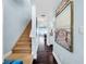 Hallway showing staircase, artwork, and dark hardwood floors at 525 Bahia Beach Blvd, Ruskin, FL 33570