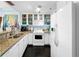 Bright kitchen featuring white cabinetry, granite countertops, and modern appliances at 525 Bahia Beach Blvd, Ruskin, FL 33570