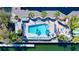 Overhead shot of a sparkling pool area with lounge chairs, palm trees, and a nearby marina at 525 Bahia Beach Blvd, Ruskin, FL 33570