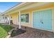 Charming home featuring a covered front entrance with brick pavers and a sunny yellow exterior at 571 Johns Pass Ave, Madeira Beach, FL 33708