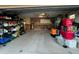 Functional garage with extensive shelving, storage, and two bicycles, ideal for organization at 571 Johns Pass Ave, Madeira Beach, FL 33708