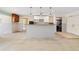 Spacious kitchen with a kitchen island, white cabinets and some new appliances, ideal for renovations at 571 Johns Pass Ave, Madeira Beach, FL 33708