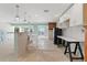 Bright kitchen featuring an island with granite countertop and a farmhouse sink at 571 Johns Pass Ave, Madeira Beach, FL 33708