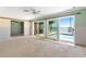Spacious living room with sliding doors, a ceiling fan, and water views at 571 Johns Pass Ave, Madeira Beach, FL 33708
