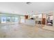 Spacious living room with water views through sliding glass doors leading to an outdoor area with a pool at 571 Johns Pass Ave, Madeira Beach, FL 33708