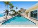 Sparkling backyard pool with lush landscaping and direct waterfront access at 571 Johns Pass Ave, Madeira Beach, FL 33708