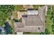 Aerial view of the home and roofline plus an outdoor patio area and backyard at 5905 Caroline Dr, Wesley Chapel, FL 33545