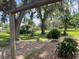 View of the backyard featuring lush trees, flowers, and a shed at 5905 Caroline Dr, Wesley Chapel, FL 33545
