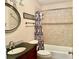 Bathroom featuring a tiled shower, round mirror and vanity cabinet at 5905 Caroline Dr, Wesley Chapel, FL 33545