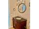 Bathroom featuring a vanity with a dark countertop and a round mirror at 5905 Caroline Dr, Wesley Chapel, FL 33545