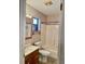 Updated bathroom with wood vanity, mirror, window, and shower-tub combination at 5905 Caroline Dr, Wesley Chapel, FL 33545