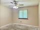 This simple bedroom has a ceiling fan and a window for natural light at 5905 Caroline Dr, Wesley Chapel, FL 33545