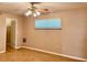 This bedroom has hardwood flooring, a ceiling fan and a window for natural light at 5905 Caroline Dr, Wesley Chapel, FL 33545