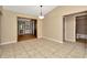 Bright dining room with tile floors, tan walls, and an adjacent bathroom and doorway at 5905 Caroline Dr, Wesley Chapel, FL 33545