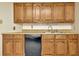 Classic kitchen featuring wood cabinets, tile backsplash, and durable countertops at 5905 Caroline Dr, Wesley Chapel, FL 33545
