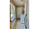 Well-lit laundry room with tile flooring, window, and updated washer and dryer at 5905 Caroline Dr, Wesley Chapel, FL 33545
