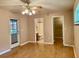 Spacious living room featuring hardwood floors, ceiling fan, and access to the bathroom and closet at 5905 Caroline Dr, Wesley Chapel, FL 33545