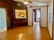 Cozy living room with hardwood floors and wood paneling, creating a rustic and inviting atmosphere at 5905 Caroline Dr, Wesley Chapel, FL 33545