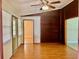 Charming living room with hardwood floors, wood paneling, and abundant natural light at 5905 Caroline Dr, Wesley Chapel, FL 33545