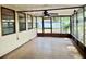 Enclosed outdoor patio area with tile floors, screen windows, and a ceiling fan at 5905 Caroline Dr, Wesley Chapel, FL 33545