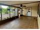 Spacious screened patio with tile flooring and ceiling fan overlooking backyard at 5905 Caroline Dr, Wesley Chapel, FL 33545