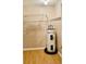 The image shows a utility closet with a hot water heater and wire shelving at 5905 Caroline Dr, Wesley Chapel, FL 33545