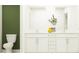 Bright bathroom featuring double vanity, modern fixtures, and a plant for added elegance at 7730 Painted Sky Pl, Land O Lakes, FL 34637
