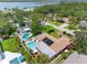 Aerial view of a property with a swimming pool, manicured lawn, and surrounding trees at 8300 37Th N Ave, St Petersburg, FL 33710