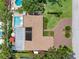 Overhead shot revealing a home's roof, pool area with furniture, and landscaped backyard at 8300 37Th N Ave, St Petersburg, FL 33710