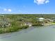 Picturesque aerial view showcasing waterfront homes with mature trees, blending luxury with the beauty of nature at 8300 37Th N Ave, St Petersburg, FL 33710