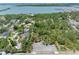 Aerial view of a residential area with lush greenery, showcasing proximity to the serene bay and park at 8300 37Th N Ave, St Petersburg, FL 33710
