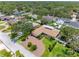 Aerial view of a home with a circular driveway and lush yard with mature trees at 8300 37Th N Ave, St Petersburg, FL 33710